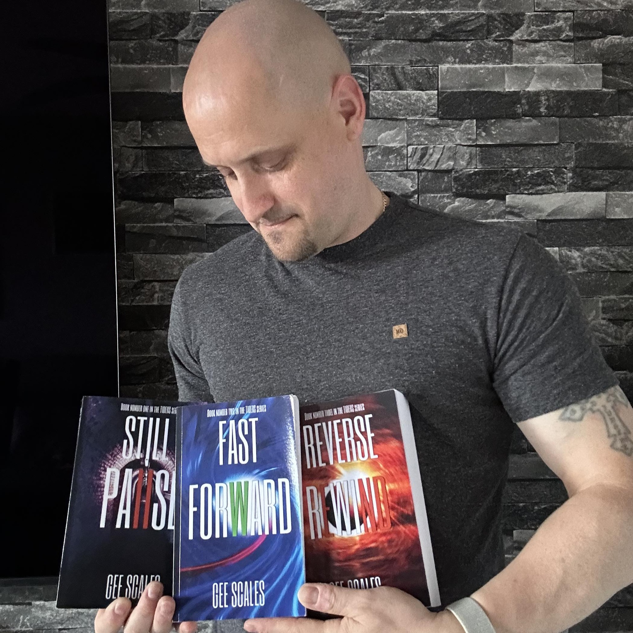 Gee Scales holding the three Tiders novels